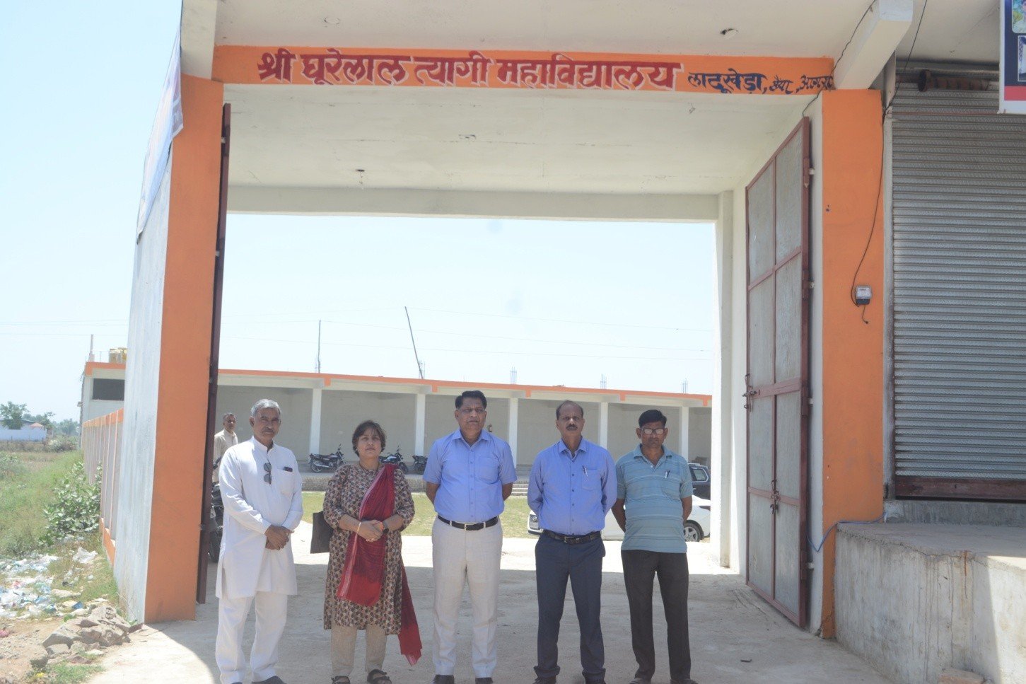 Faculty standing at the college entrance